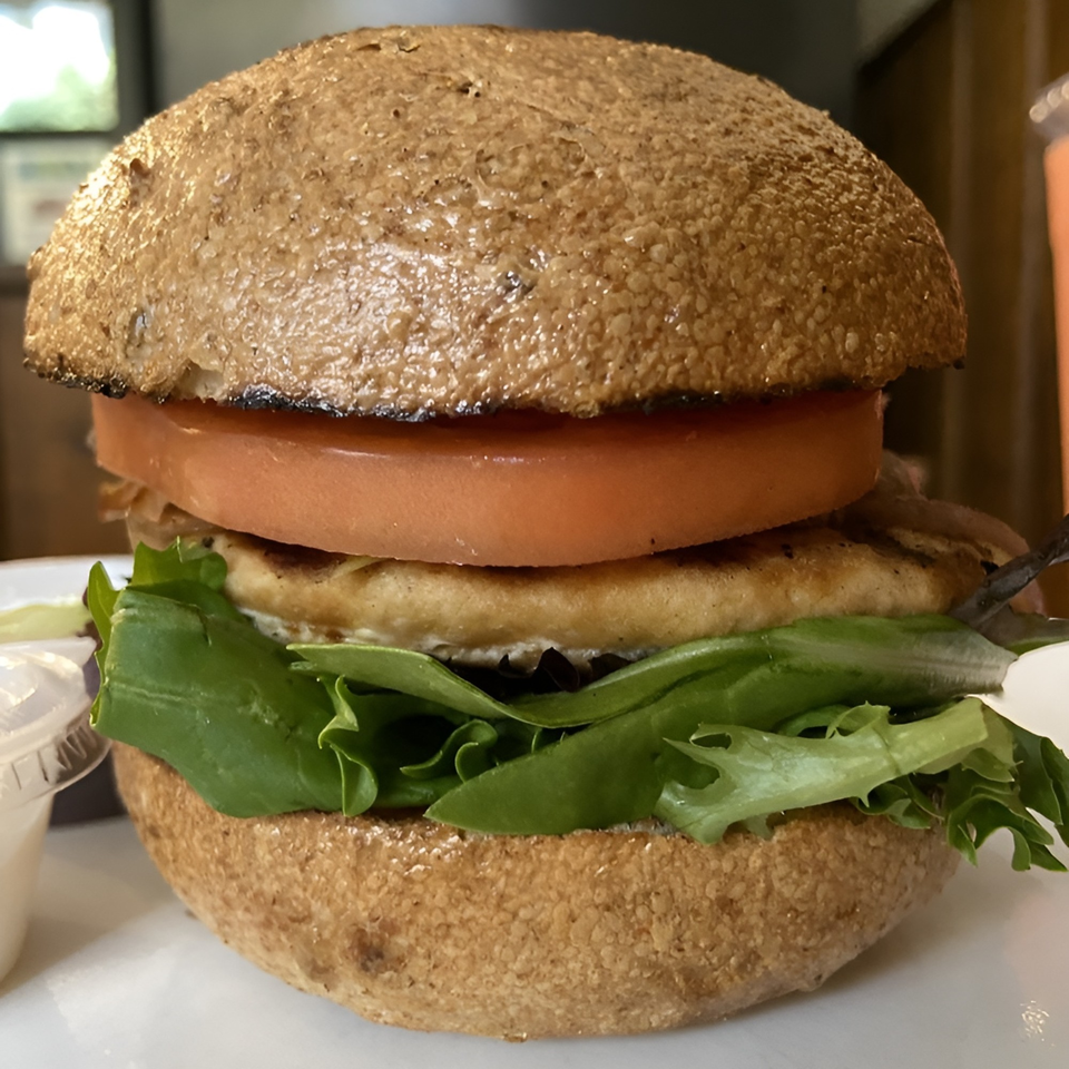 A healthy chicken sandwich with lettuce and tomato on a whole wheat bun from Meme's Healthy Nibbles.
