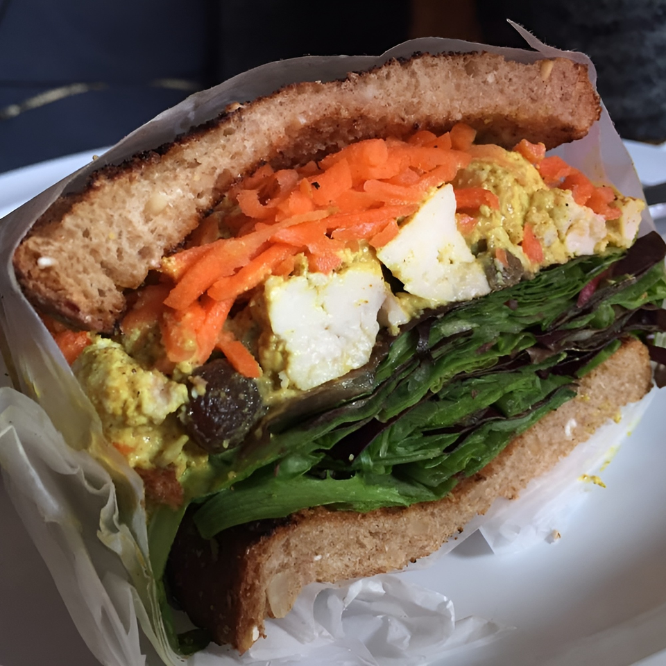 A healthy sandwich from Meme's Healthy Nibbles, with shredded carrots, lettuce, and chicken salad.